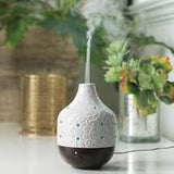 Decorative diffuser with colorful stones on a blurred background
