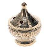Decorative brass incense burner with star designs on a white background