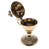 Decorative brass incense holder with open lid on a white background