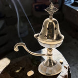 Silver incense burner on a dark surface