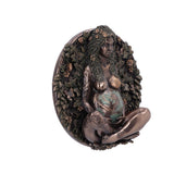 Decorative wall piece of a woman with greenery and flowers on a white background