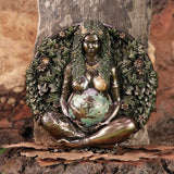 Decorative wall piece of a pregnant woman surrounded by foliage on a stone background