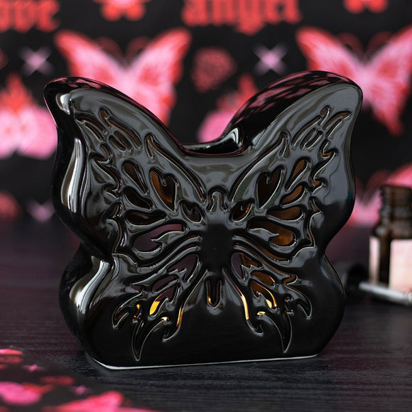 Black butterfly-shaped object with a blurred butterfly design in the background