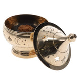 Decorative metal grinder with star and moon designs on a white background