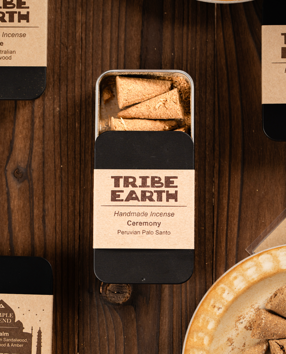 Tribe Earth handmade incense packaging on a wooden surface