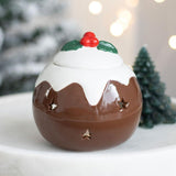 Decorative Christmas pudding ornament with a star on a white surface.