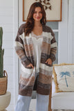 Woman wearing a patterned cardigan in a home setting
