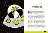An interior spread of a tarot deck booklet showing the Cosmic C't Tarot card design on the left and an introduction page on the right. The card features a white crescent moon with a yellow-green alien figure inside, set against a black starry background.