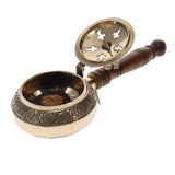 Decorative incense holder with wooden handle and intricate design on a white background