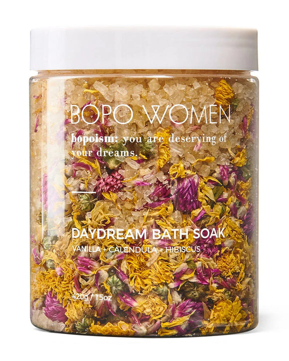 Bath soak with flowers in a jar labeled 'BOPO WOMEN' on a white background