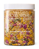 Bath soak with flowers in a jar labeled 'BOPO WOMEN' on a white background
