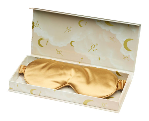 Gold satin eye mask in a decorative box with celestial designs.