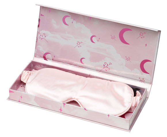 Pink sleep mask in a decorative box with cloud and moon designs.