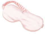 Pink satin eye mask on a white background