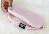 Pink satin eye mask with 'Summer Salt Body' label on a white background