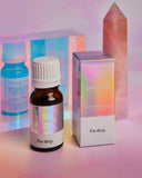 Essential oil bottle and packaging with 'Dreamer' branding on a colorful background