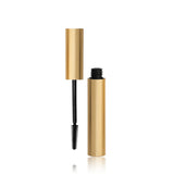 Gold and black mascara tube on a white background