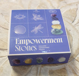 Box of empowerment stones with illustrations on a textured surface