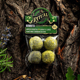 Packaged bath bombs with 'Ritual' branding on a wooden background