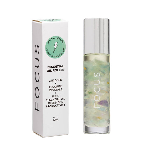 A product image showing a 10ml essential oil roller bottle next to its packaging. The packaging is labeled 'FOCUS' and includes mentions of '24K Gold' and 'Fluorite Crystal', indicating the blend's infused properties.