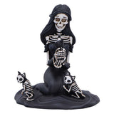 Skeletal mermaid figurine with two skeleton cats on a white background