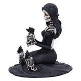 Skeletal mermaid figurine with two skeleton dogs on a white background