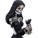 Skeleton figurine with black hair and a cat, on a white background