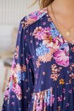 Navy blue dress with colorful floral pattern worn by a person.