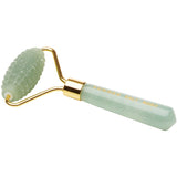 Jade facial roller with gold accents on a white background