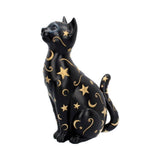 Black cat figurine with gold stars and moons on a white background