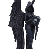 Black angel figurine with wings holding a book featuring a skull on a white background