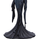 Dark, ornate figurine with intricate detailing on a white background