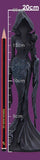 Black hooded dress with intricate detailing on a purple background, accompanied by a ruler for scale.