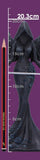 A dark gothic mermaid figurine with a hooded angel-like head and wings, shown next to a pencil and a measuring tape on a purple background with height markings.