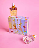 Perfume bottle with decorative box on a pink background