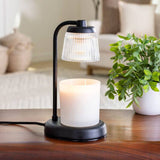Table lamp with a candle on a wooden surface in a living room setting