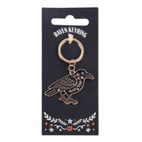 Raven keyring on a black card with decorative elements