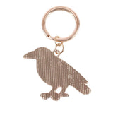 Rose gold bird-shaped keychain on a white background