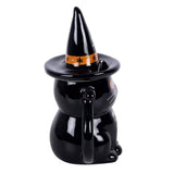 Black ceramic cat-shaped teapot with a witch hat on a white background