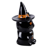 Black cat figurine wearing a witch hat with orange band on a white background