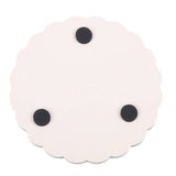Round white coaster with black dots on a white background