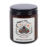 Spiced vanilla scented candle with decorative label on a white background