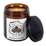 Spiced vanilla scented candle in an amber jar with a decorative label on a white background