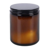 Amber glass jar with a black lid on a white background