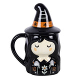 Black mug with witch design and Halloween-themed lid on a white background