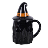 Black mug with witch hat lid on a white background