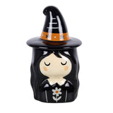 Ceramic witch figurine with a black hat and flower design on a white background