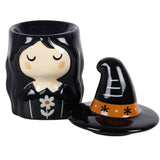 Ceramic witch figurine with a hat on a white background