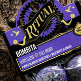 Purple packaging with 'Ritual Bombita' branding on a textured surface