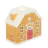 Decorative gingerbread house with a red door on a white background